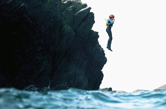 person diving from a cliff