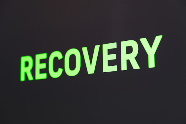 word recovery produced in large green glowing letters