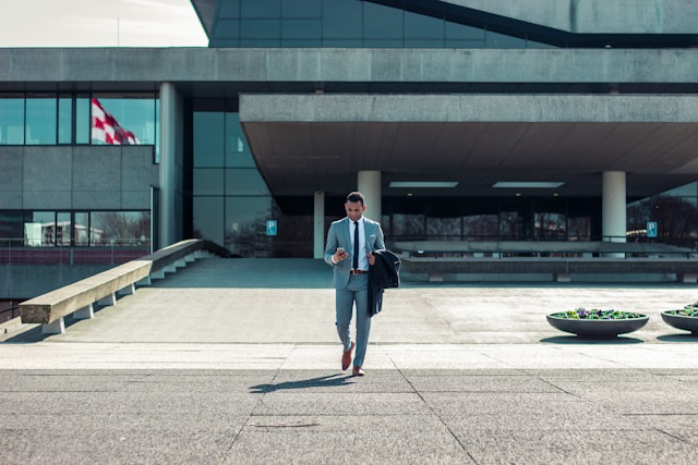 man in suit walking outside building