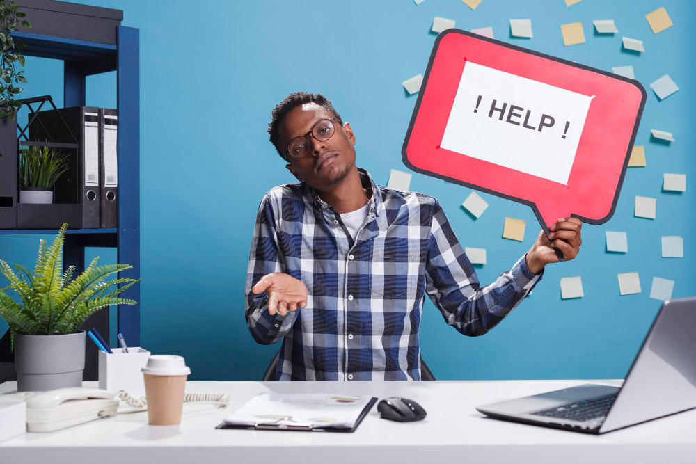 office worker with a sign saying help