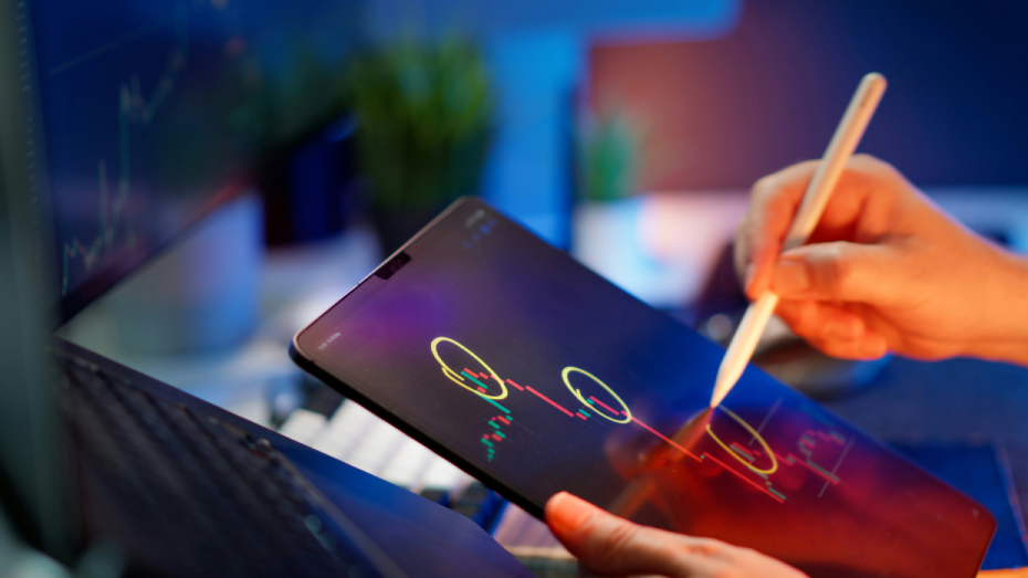 someone-is-working-on-the-tablet-to-analyze-stock-data