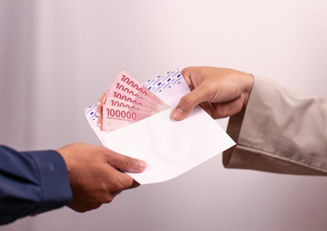 money in envelope handed between persons