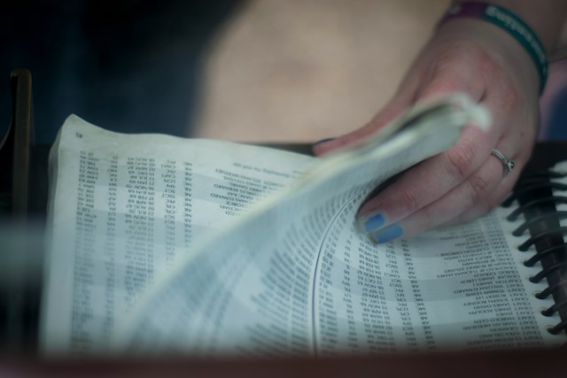 person flipping through a phonebook